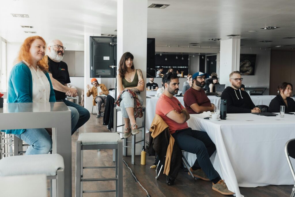 Audience seated and attentively listening during a corporate presentation for event marketing.